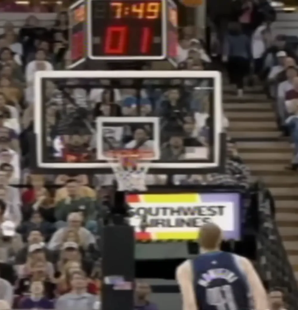 Dirk Nowitzki watches a shot from beneath the shot clock